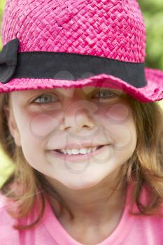 Head And Shoulders Portrait Of Girl Wearing Pink Straw Hat