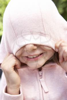 Portrait Of Girl Hiding Face In Pink Hooded Top