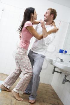 Couple Having Fun In Bathroom Brushing Teeth