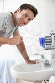 Man In Bathroom Brushing Teeth