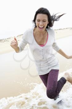 Woman Running Along Beach