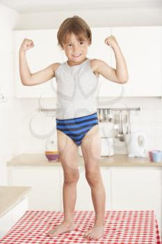 Boy Standing On Kitchen Table In Underwear