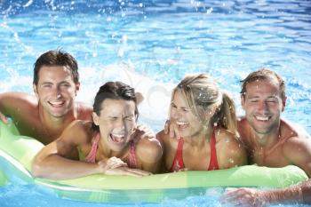 Group Of Friends On Holiday In Swimming Pool