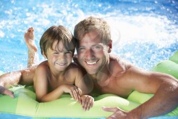 Father And Son On Holiday In Swimming Pool