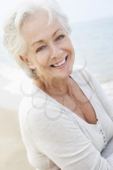Senior Woman Standing On Beach