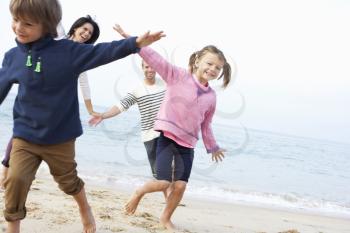 Family Playing On Beach Together