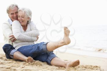 Senior Couple Sitting On Beach Together