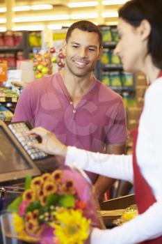 Customer Paying For Shopping At Supermarket Checkout