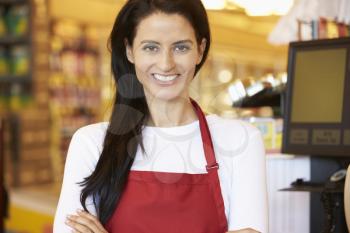 Female Cashier At Supermarket Checkout