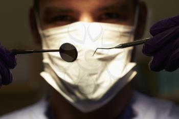 Close Up Of Dentist Holding Dental Examination Equipment