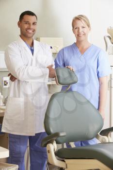 Portrait Of Dentist And Dental Nurse In Surgery