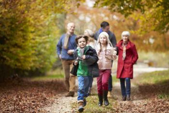 Multl Generation Family Walking Along Autumn Path