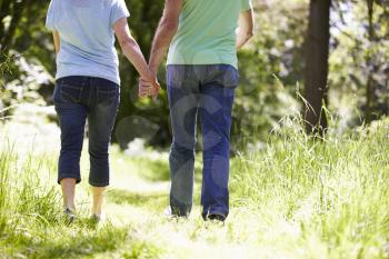 Close Up Of Senior Couple Walking In Summer Countryside