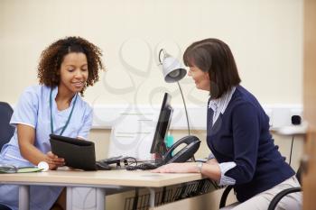 Nurse Showing Patient Test Results On Digital Tablet