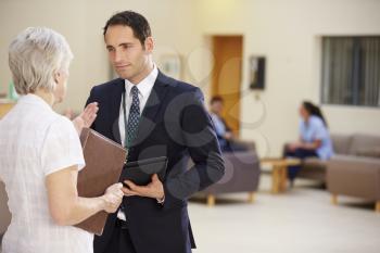 Two Consultants Discussing Patient Notes In Hospital