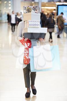 Female Shopper Hidden Behind Boxes Shopping In Mall