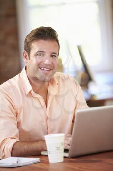 Man Working At Laptop In Contemporary Office