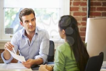 Businessman Interviewing Female Job Applicant In Office