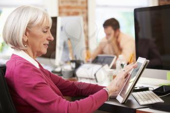 Businesswoman Using Digital Tablet In Creative Office
