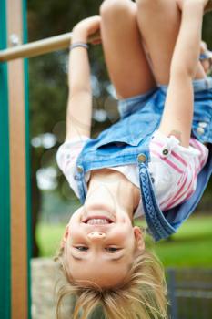 Young Girl On Climbing Frame In Playground