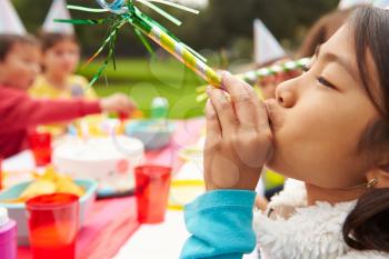 Girl With Blower At Outdoor Birthday Party