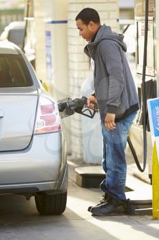Male Driver Filling Car At Gas Station