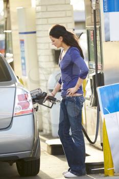 Female Driver Filling Car At Gas Station