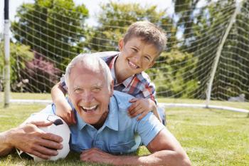 Portrait Of Grandfather And Grandson With Football