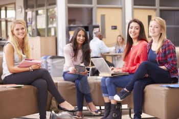 Female College Students Sitting And Talking Together