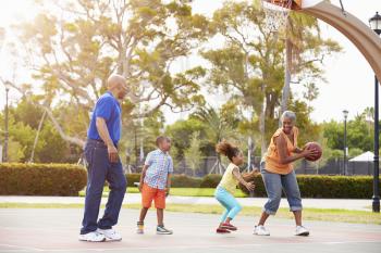 Grandparents And Grandchildren Playing Basketball Together