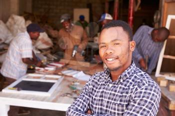 Portrait of man in a busy carpentry workshop, South Africa