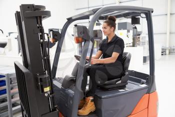 Female Fork Lift Truck Driver Working In Factory