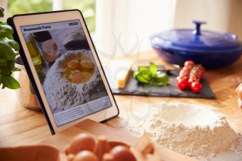 Following Pasta Recipe Using App On Digital Tablet