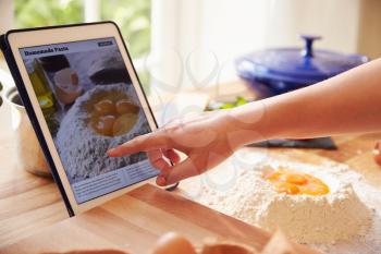 Person Following Pasta Recipe Using App On Digital Tablet