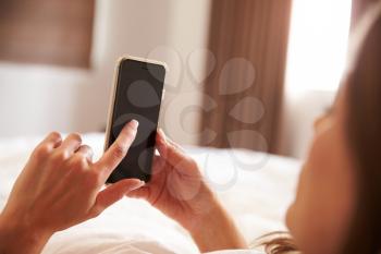 Woman Lying In Bed Whilst Mobile Phone