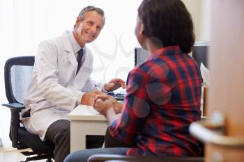 Female Patient Having Consultation With Doctor In Office
