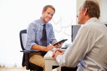 Male Patient Having Consultation With Doctor In Office