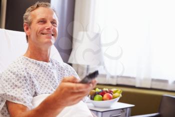 Male Patient In Hospital Bed Watching Television