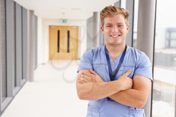Portrait Of Male Nurse Standing In Hospital Corridor