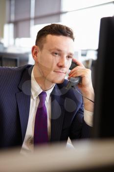 Young businessman using phone, vertical portrait