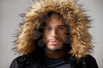 Studio Portrait Of Young Man Wearing Winter Coat
