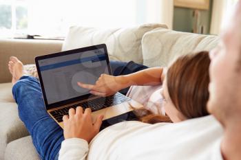 Couple Relaxing Using Laptop Computer For Internet Banking