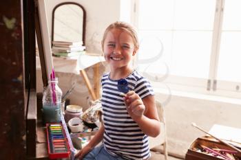 Portrait Of Young Girl Working On Painting In Studio