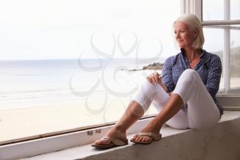 Woman Sitting At Window And Looking At Beautiful Beach View