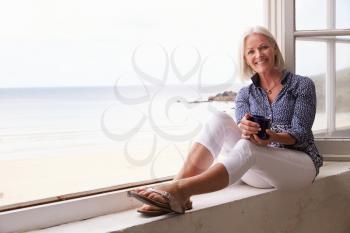 Woman Sitting At Window And Looking At Beautiful Beach View