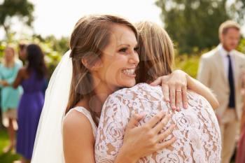 Bride Hugging Mother On Wedding Day