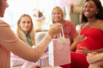 Close Up Of Gift For Pregnant Woman At Baby Shower