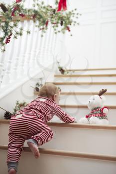 Young Girl On Stairs In Pajamas At Christmas
