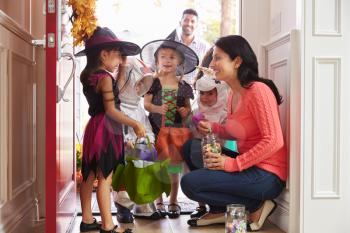 Children In Halloween Costumes Trick Or Treating