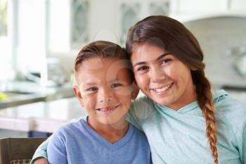 Head And Shoulders Portrait Of Hispanic Children At Home